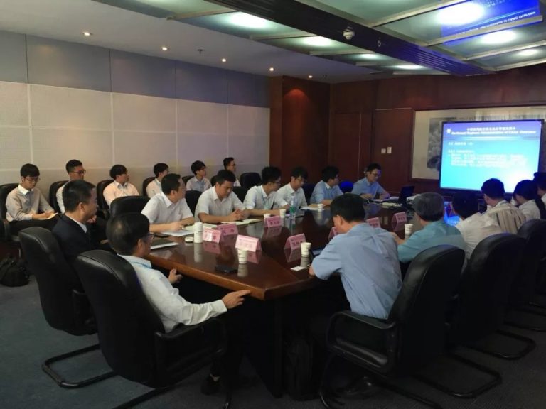 Group of professionals in a conference room during a presentation.