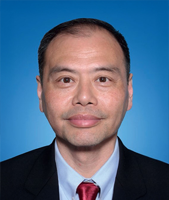 Portrait of a man in suit and red tie against blue background