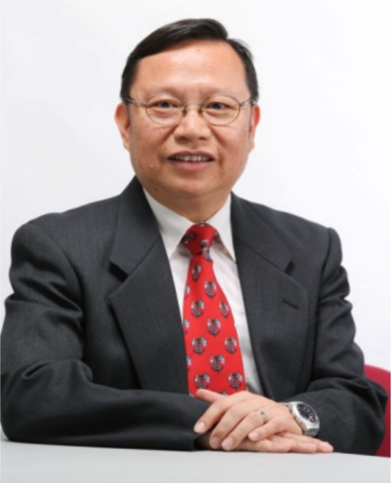 Man in suit and glasses smiling at camera with red patterned tie
