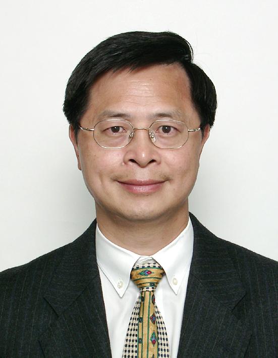 Portrait of a man with glasses wearing a suit and patterned tie.