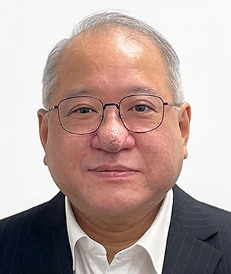 Portrait of a man with glasses and suit, likely a business professional.