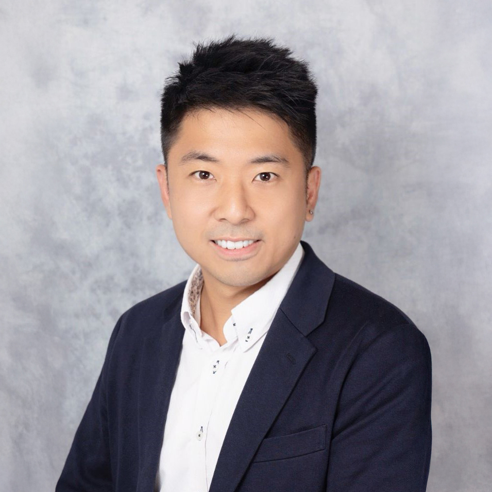 Portrait of Ir Calvin LEUNG, smiling, wearing a dark blazer and white shirt.