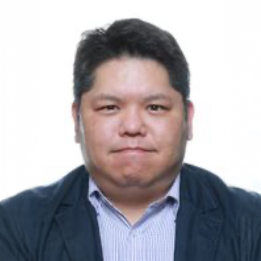Portrait of David Chau wearing a dark blazer and striped shirt.