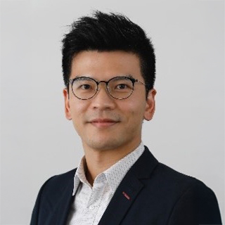 Portrait of Eric Cheung wearing glasses and a suit jacket.