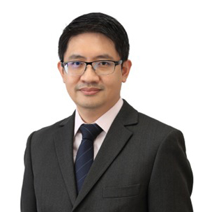 Portrait of Eric LEE wearing glasses, suit, and tie.