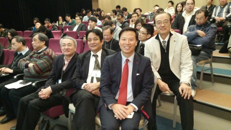 Audience at conference event, smiling attendees seated in rows