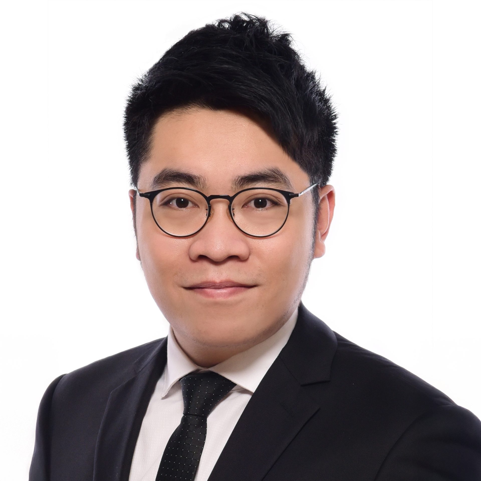 Portrait of a man with glasses wearing a suit and tie.