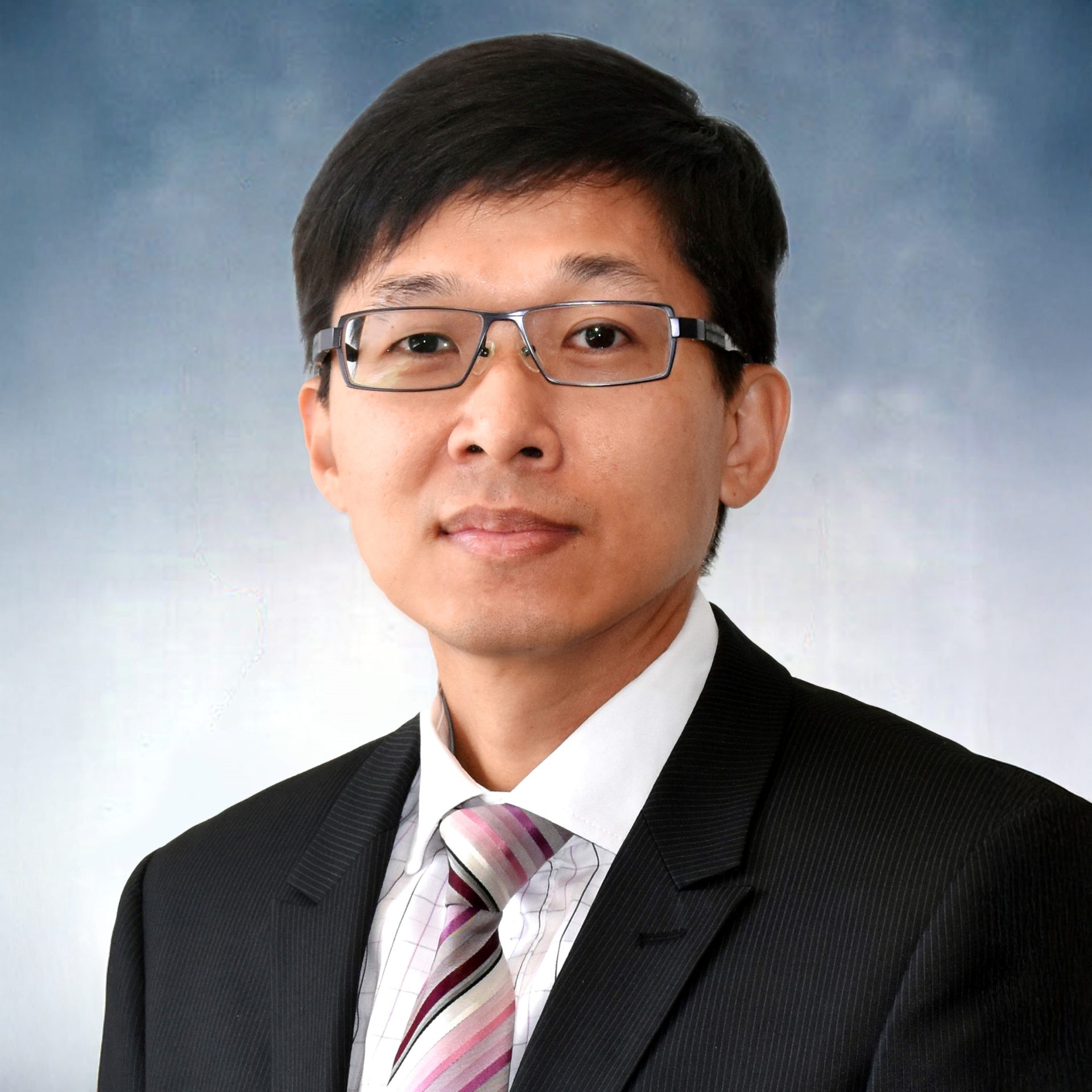 Man in glasses wearing suit and striped tie