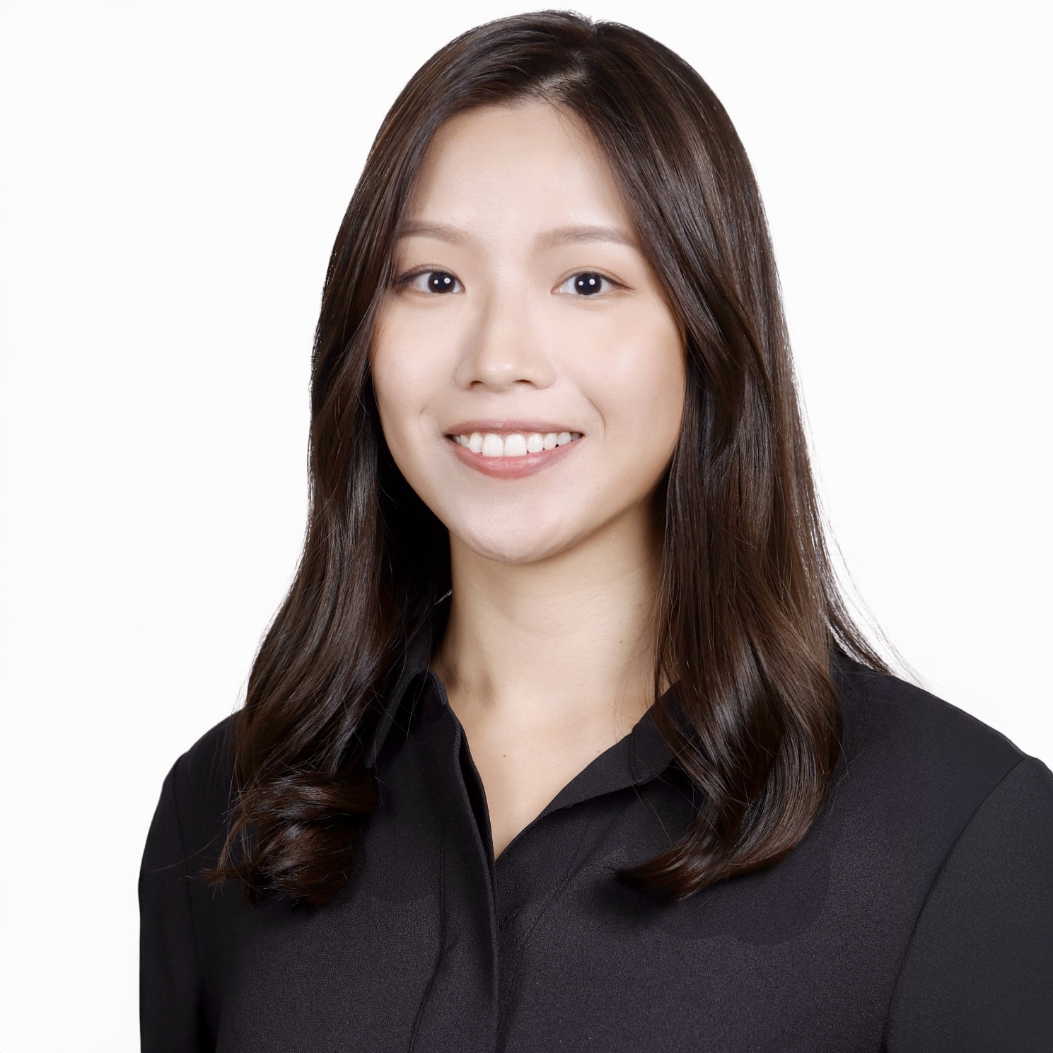 Smiling woman with long dark hair wearing black collared shirt.