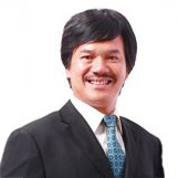 Smiling man in suit and tie against white background