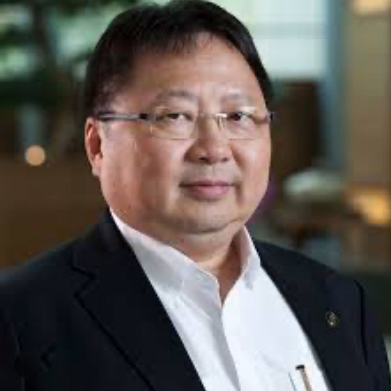 Man in glasses and suit looking at camera