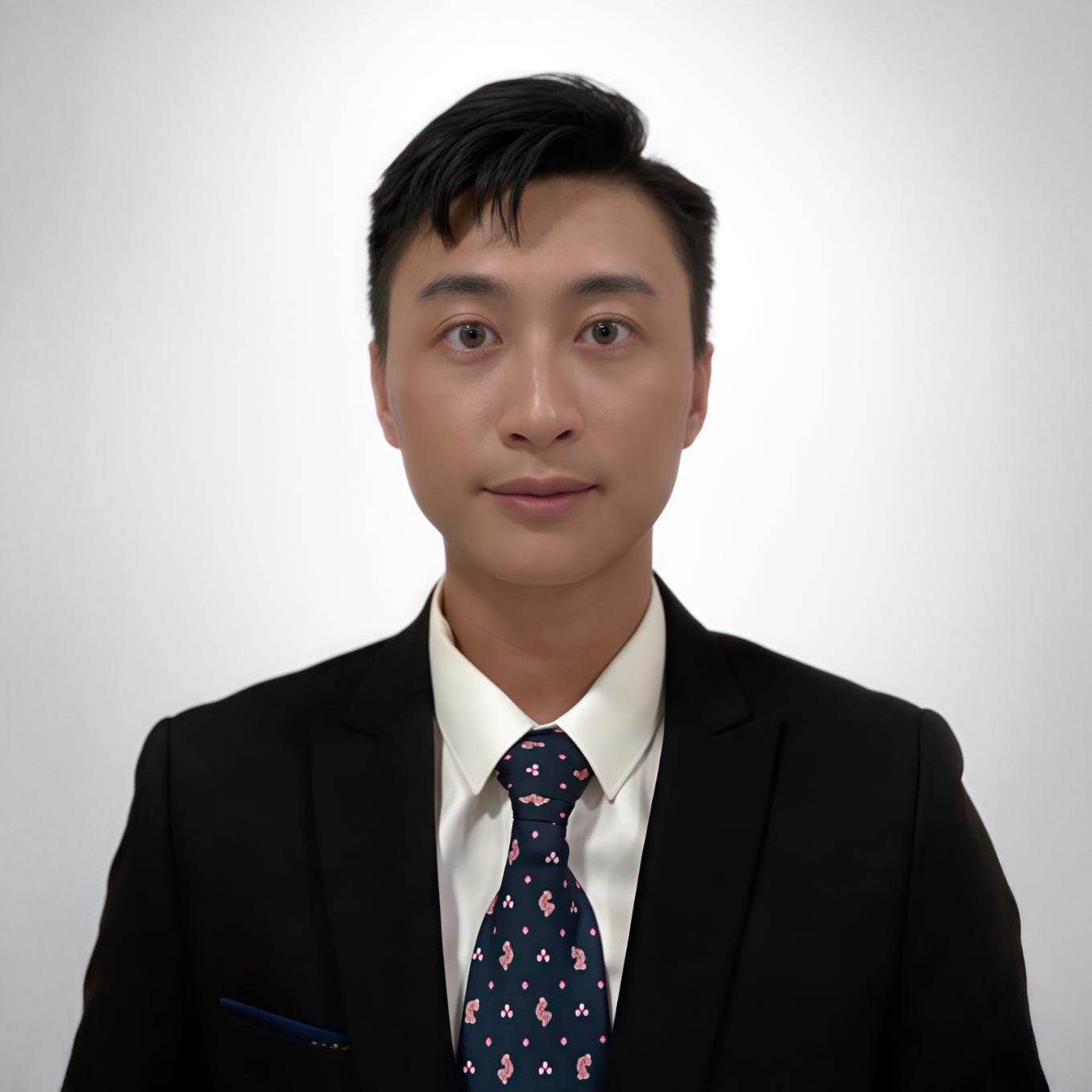 Man in suit and patterned tie against white background