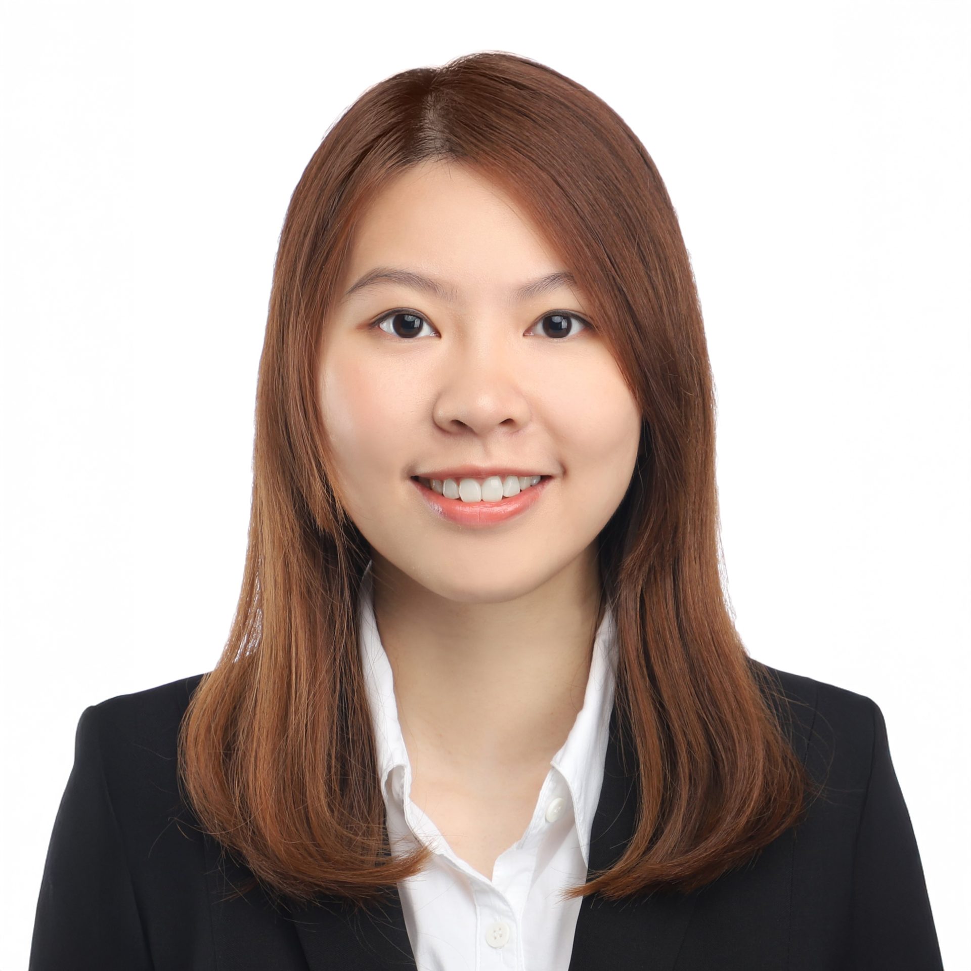 Professional headshot of a smiling woman with brown hair wearing a black blazer and white shirt.