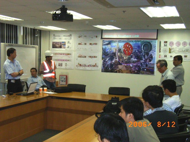 Meeting room with attendees and presentation on Kawlagan Southern Link project.