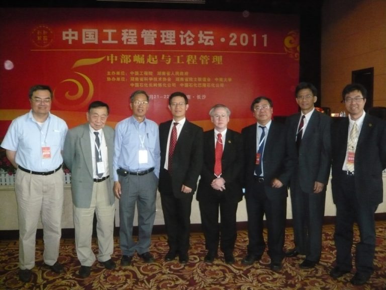 Group of seven men posing for photo at China Engineering Management Forum 2011.