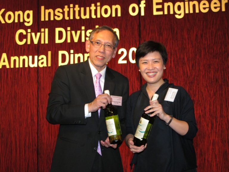 Man and woman holding wine bottles at Hong Kong Institution of Engineers Civil Division Annual Dinner 2023