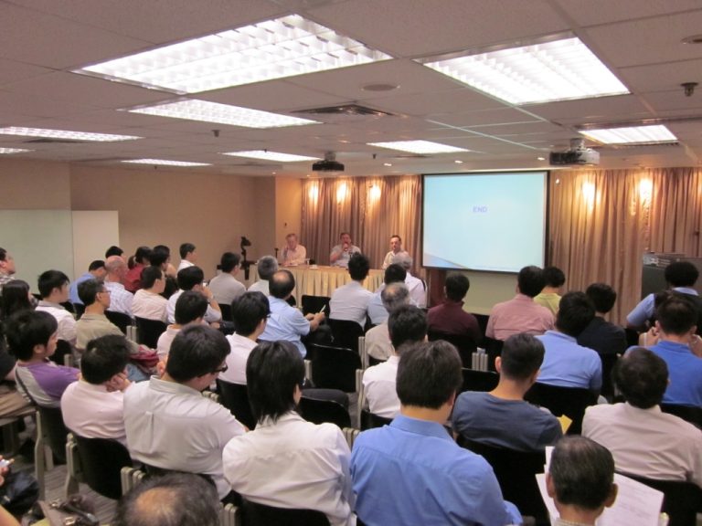 "Audience attending a presentation with ""END"" displayed on the screen."