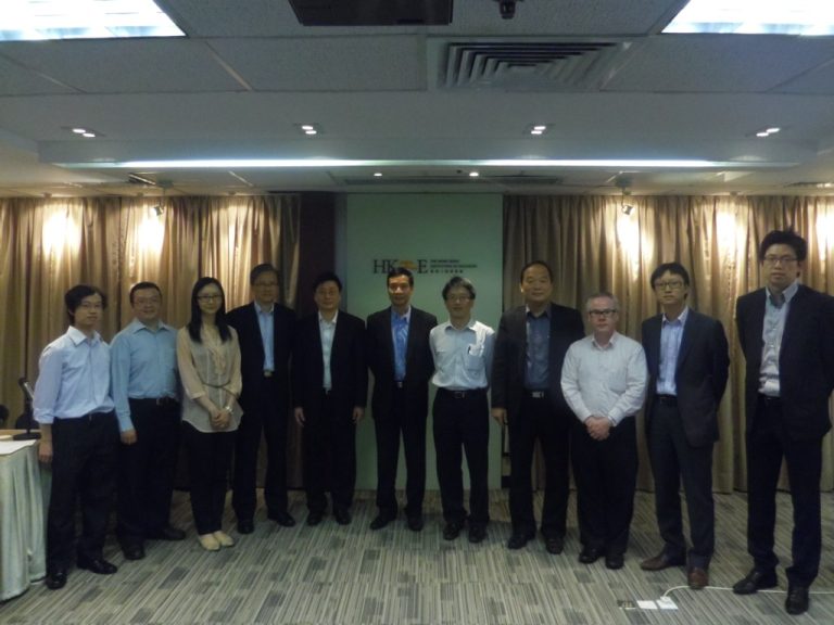 Group of professionals posing for a photo in front of HKIE logo backdrop.