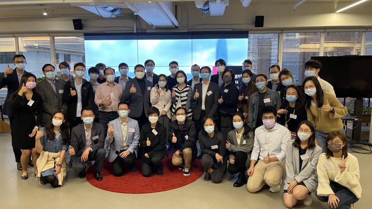 Group of people wearing masks posing for photo with thumbs up gestures