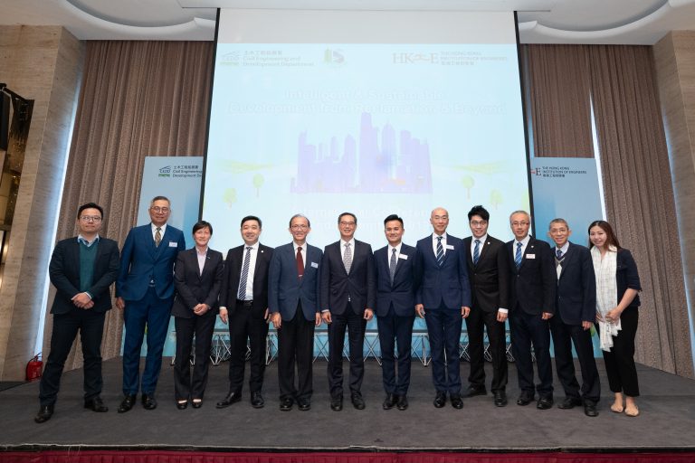 Group of professionals posing on stage at an engineering conference.