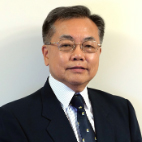 Man in suit and tie, wearing glasses, neutral expression