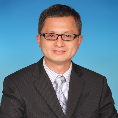 Professional headshot of Brian H.W. Ng wearing glasses and suit against blue background