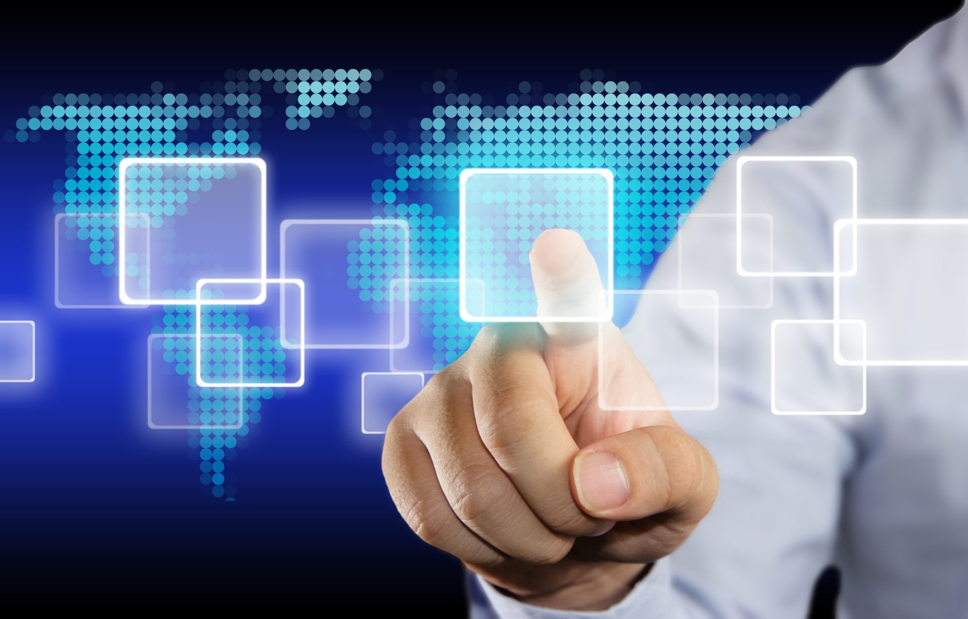 Businessman interacts with virtual touchscreen interface against world map background.