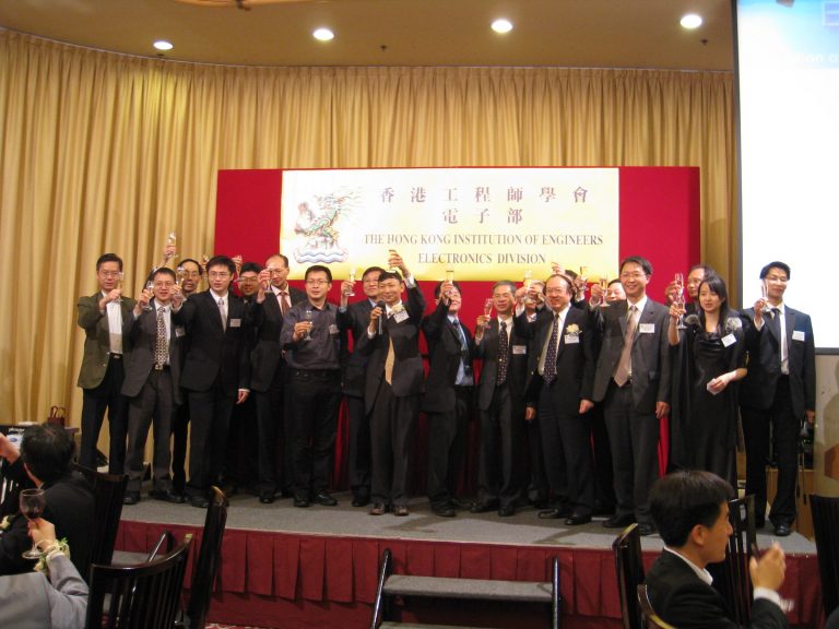 Group of professionals toasting with champagne at Hong Kong Institution of Engineers event.