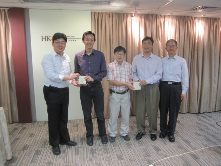 Five men posing for photo at Hong Kong Institution of Engineers seminar, two holding small boxes.