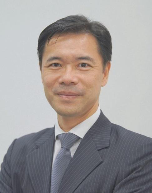 Businessman in pinstripe suit and tie, smiling at camera