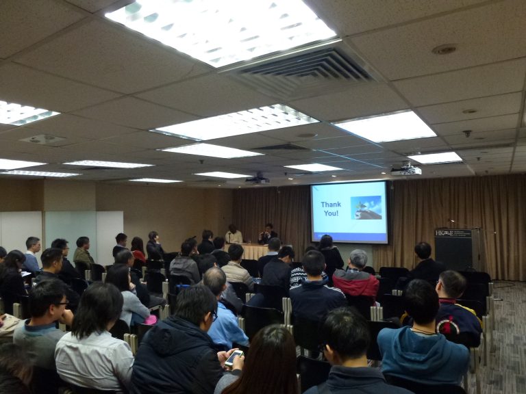"Audience attending presentation with ""Thank You!"" slide displayed on screen."