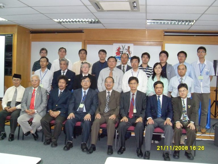 Group photo of professionals in formal attire posing for a meeting or conference on November 21, 2008.