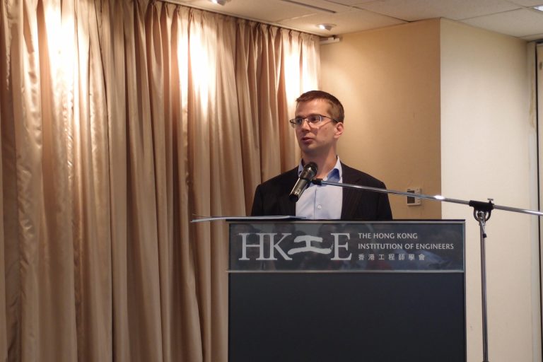 Man speaking at podium for The Hong Kong Institution of Engineers.