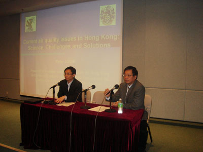 Two men speaking at a press conference about air quality in Hong Kong.