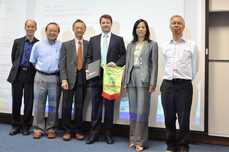 Six professionals posing for a photo at a presentation, one holding a banner from IMechE Hong Kong Branch.