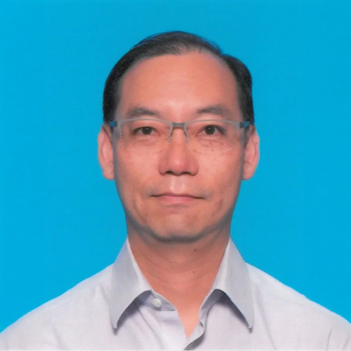 Man with glasses and light shirt against blue background