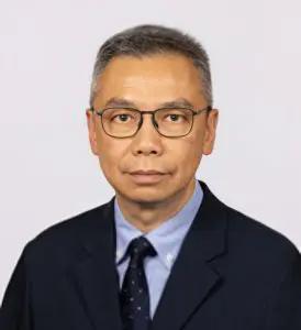 Portrait of Wong-Chun-Yip, wearing glasses, suit, and tie.