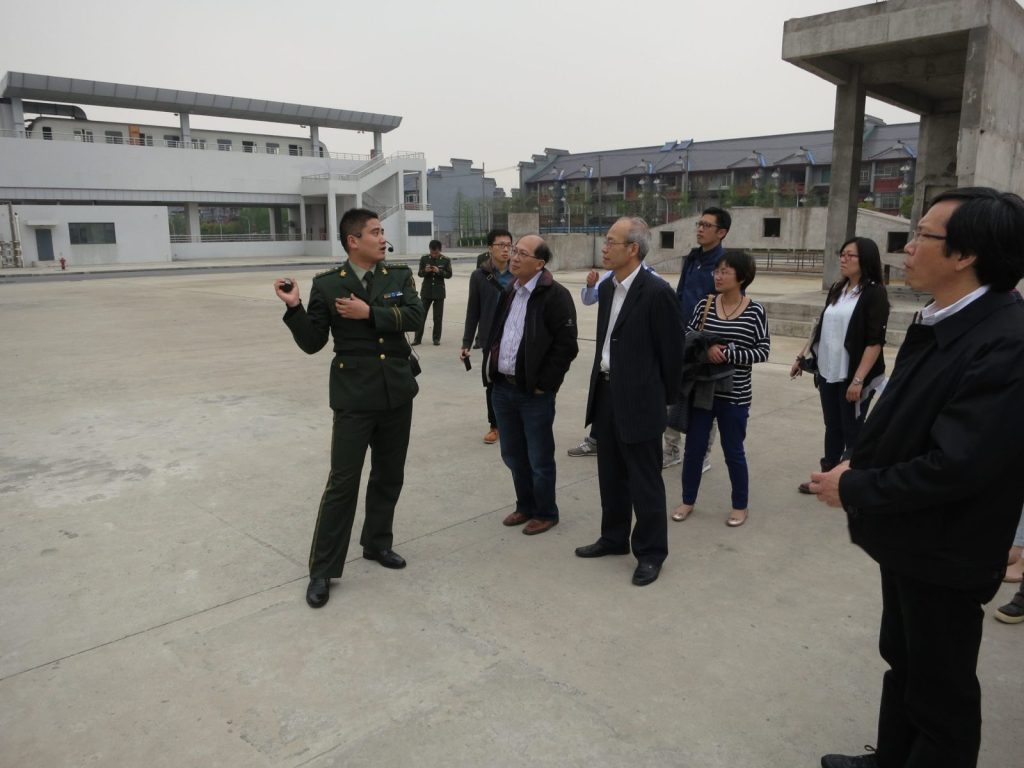 Police officer talking to people near buildings
