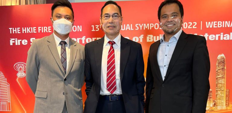 Three men in suits posing at The HKIE Fire Safety Symposium 2022 event.