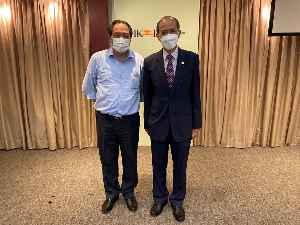 Men stand side by side behind curtain