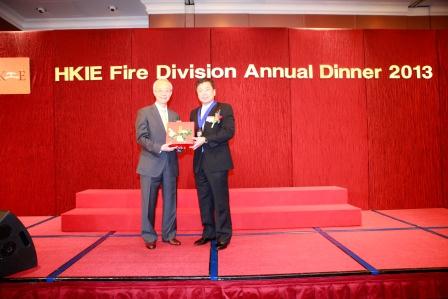 Two men in suits exchange an award on stage at HKIE Fire Division Annual Dinner 2013