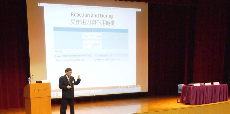 Dr. Huang presenting reaction force formulas on stage at a CPD training session.