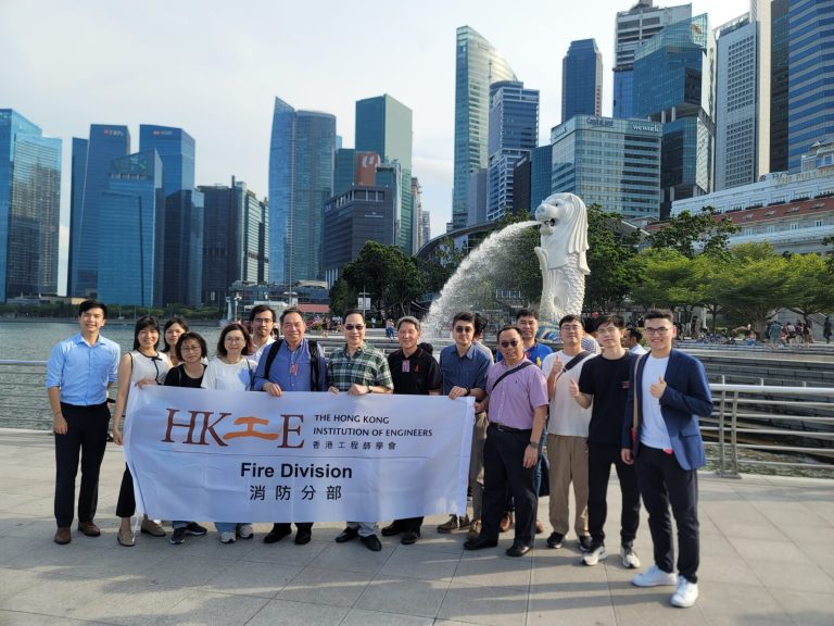 Group of engineers from Hong Kong Institution of Engineers Fire Division posing in front of Merlion statue in Singapore.