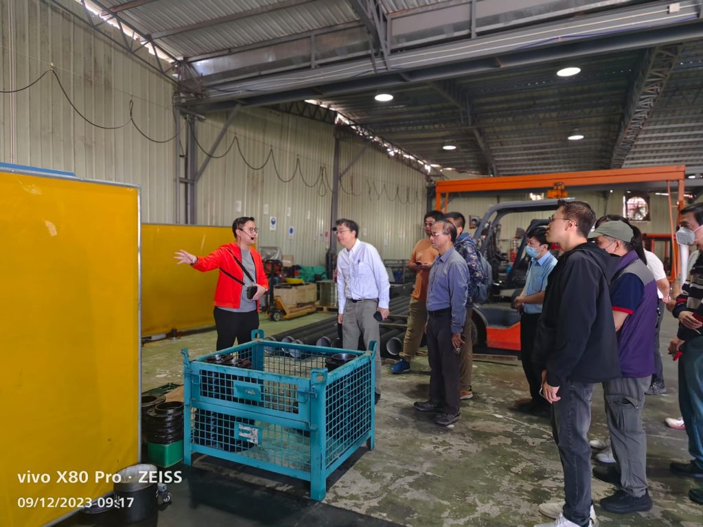 Red jacket person presenting in factory
