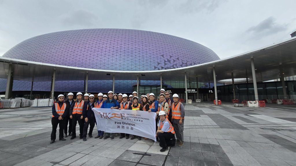 Workers hold sign outside stadium