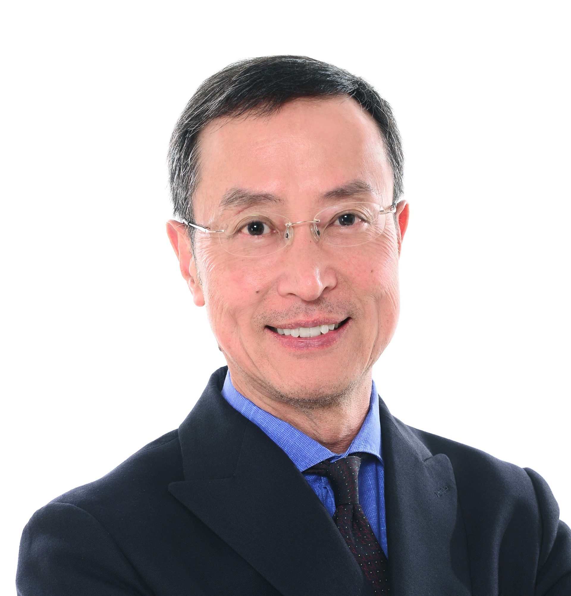 Headshot of a smiling man with glasses wearing a suit and tie.