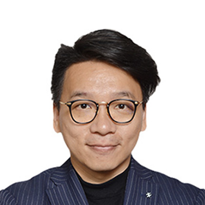 Man with glasses and dark hair wearing a pinstripe blazer over a black shirt.