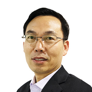 Headshot of a man with glasses wearing a suit and striped shirt