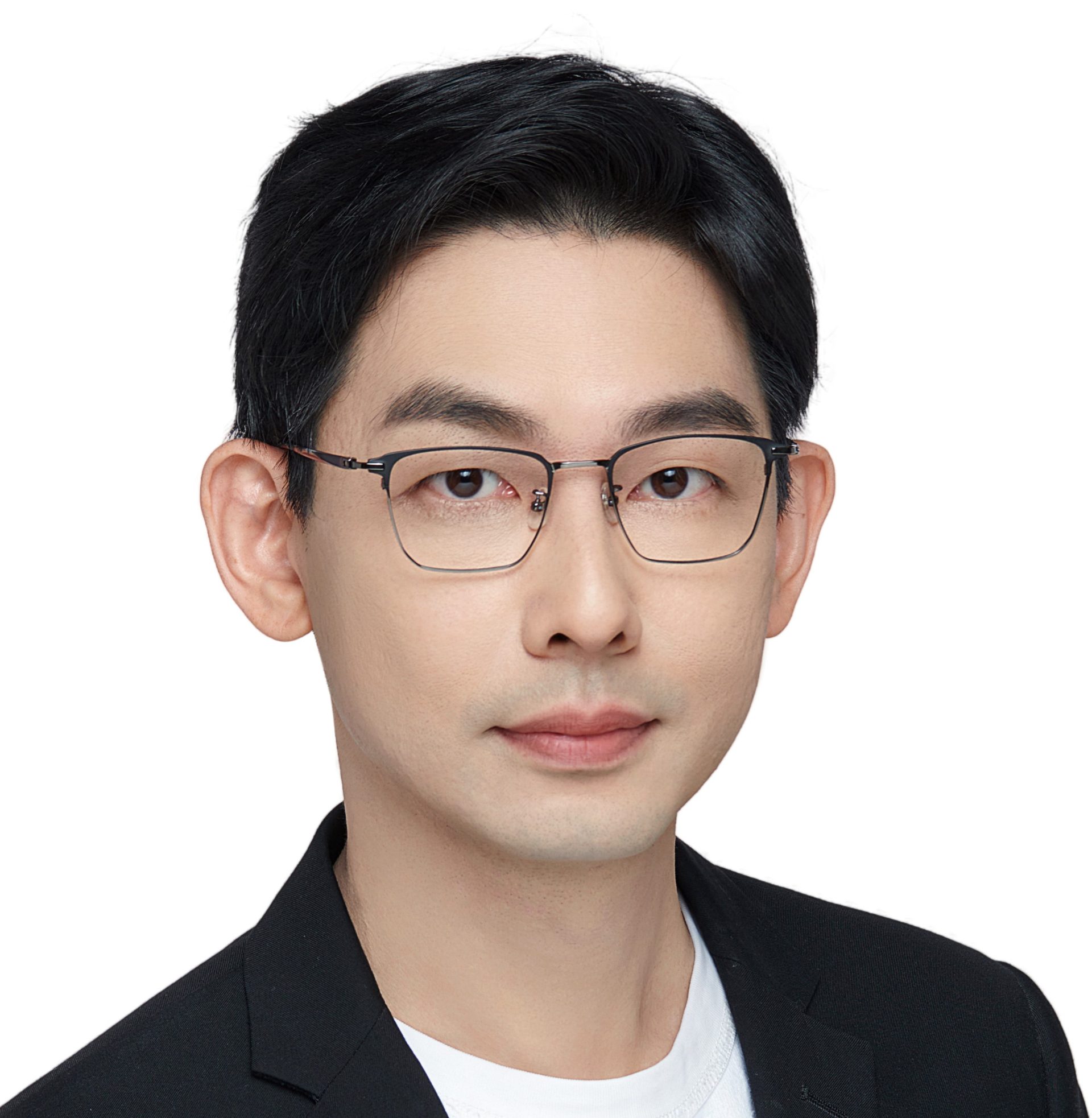 Portrait of a man with glasses wearing a black blazer over a white shirt.