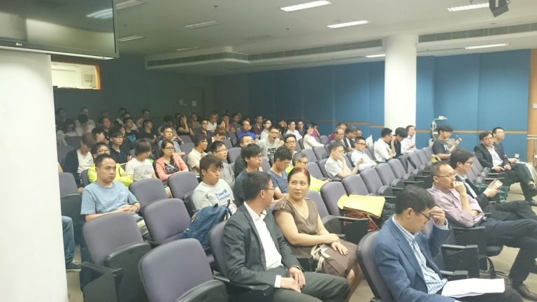 Audience seated in lecture hall attending presentation